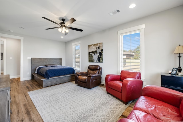 bedroom with ceiling fan and light hardwood / wood-style floors