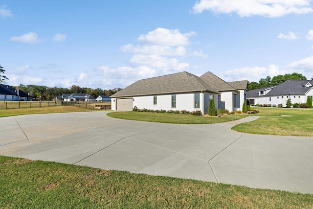 view of front facade with a garage and a front lawn