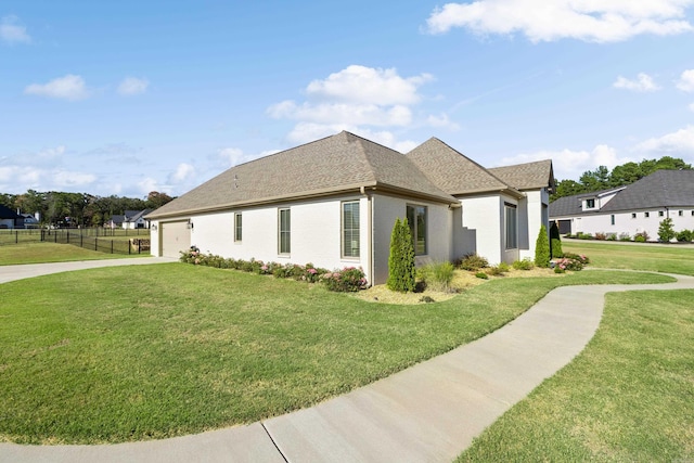 view of side of property with a lawn