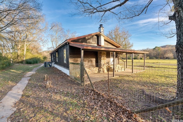 view of property exterior with central AC