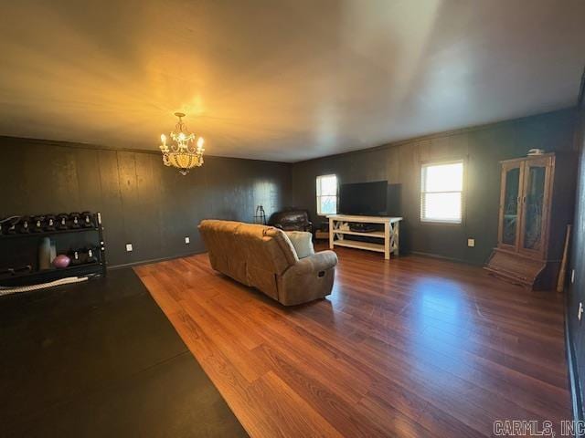 living room featuring hardwood / wood-style flooring and a notable chandelier