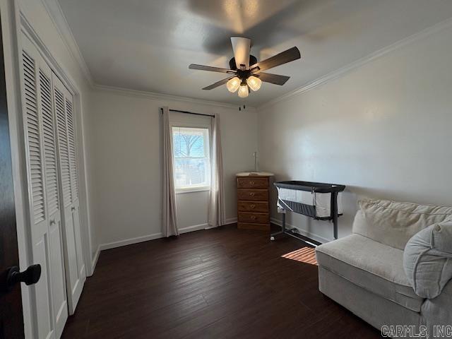 sitting room featuring ceiling fan, dark hardwood / wood-style flooring, and ornamental molding