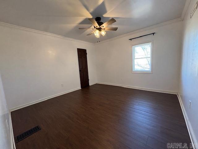 spare room with dark hardwood / wood-style floors, ceiling fan, and crown molding