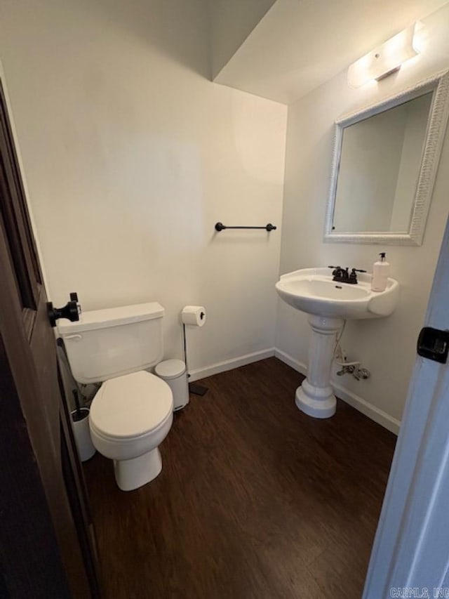 bathroom featuring hardwood / wood-style flooring and toilet