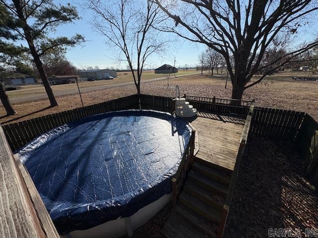 wooden deck with a covered pool