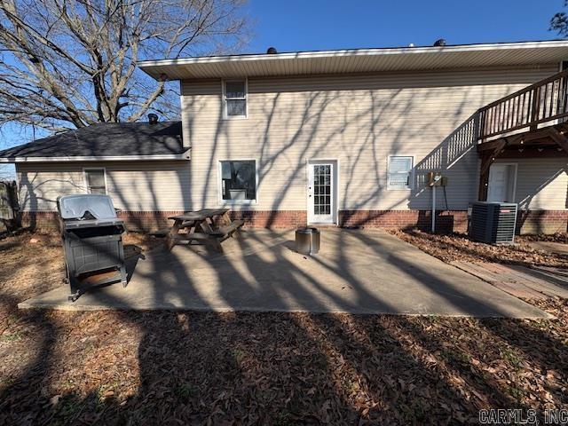 back of property featuring a patio area, central air condition unit, and a wooden deck