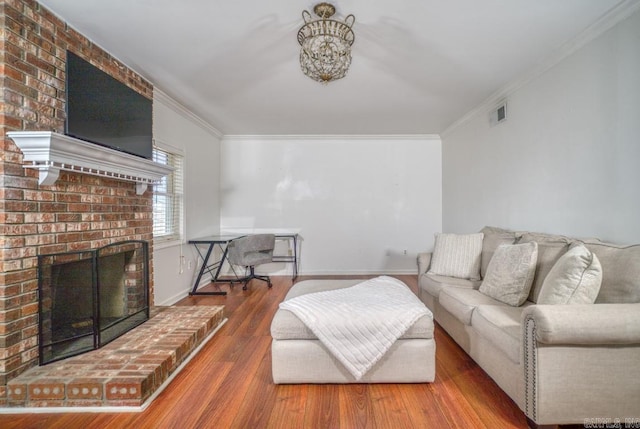 living room with a brick fireplace, crown molding, and hardwood / wood-style flooring