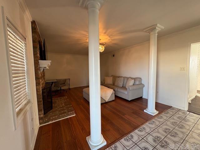 living room featuring wood-type flooring and ornamental molding