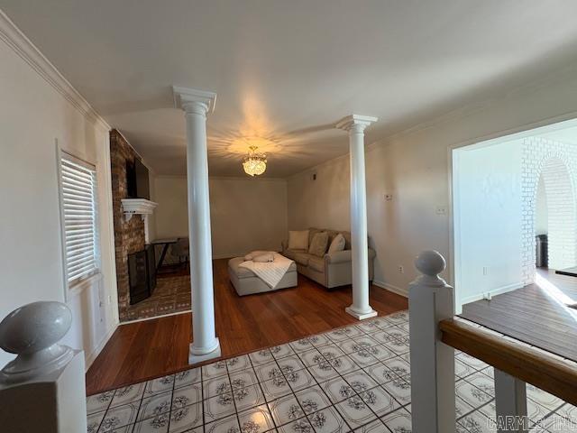 living room with crown molding, a fireplace, and light wood-type flooring