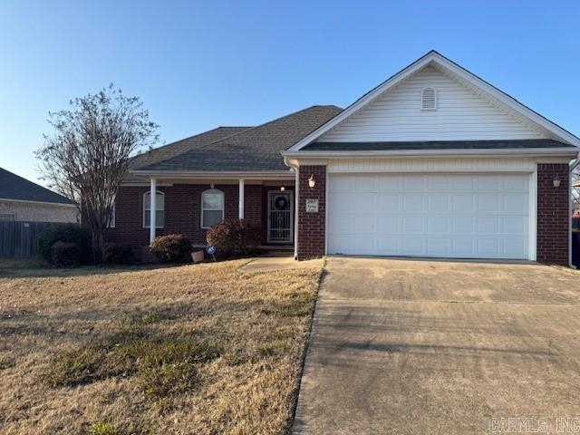 ranch-style home with a front lawn and a garage