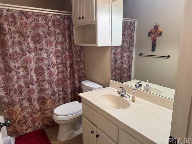 bathroom featuring tile patterned flooring, vanity, and toilet