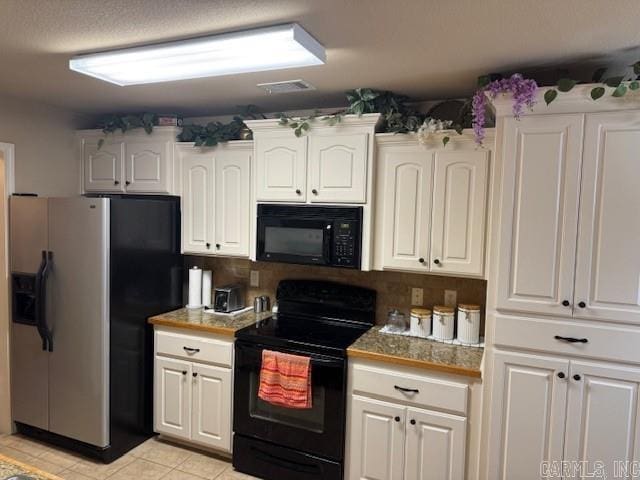 kitchen with black appliances, white cabinetry, and light tile patterned floors