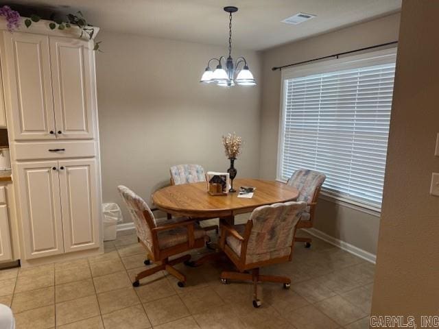 dining space featuring a chandelier, plenty of natural light, and light tile patterned flooring