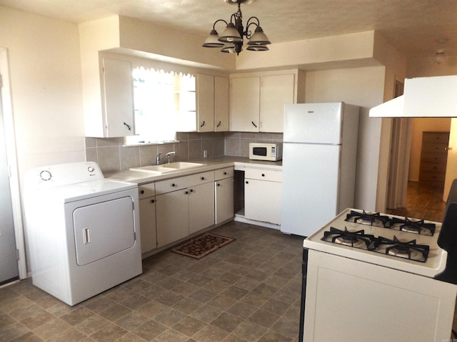 kitchen featuring white cabinetry, washer / dryer, decorative light fixtures, white appliances, and decorative backsplash