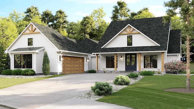 modern farmhouse featuring a porch, a garage, and a front lawn