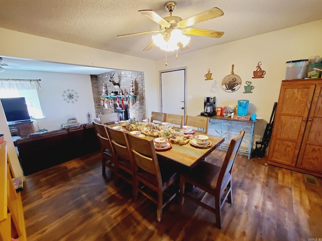 dining room featuring ceiling fan, dark hardwood / wood-style flooring, and a textured ceiling