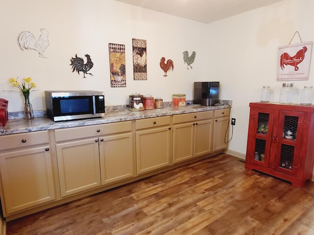 kitchen featuring cream cabinetry and light hardwood / wood-style floors