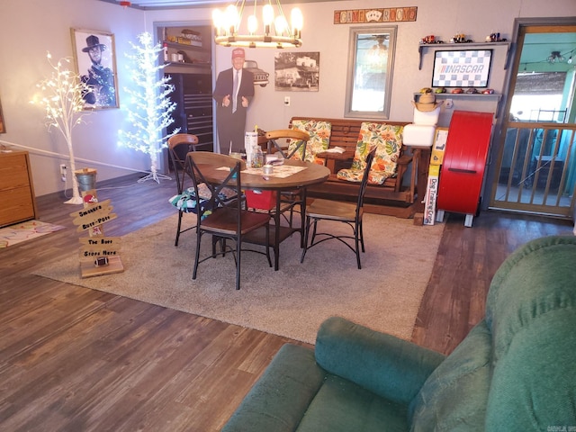 dining room with dark hardwood / wood-style floors and an inviting chandelier