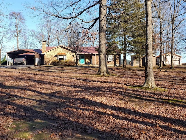 single story home featuring a carport