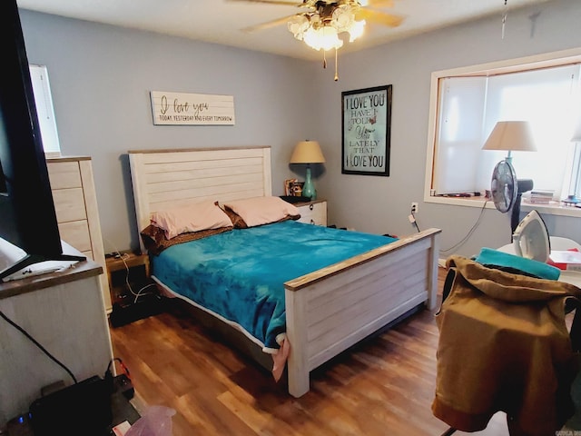 bedroom featuring dark hardwood / wood-style flooring and ceiling fan