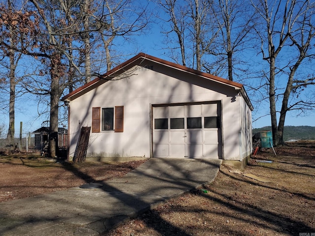 view of property exterior with an outdoor structure and a garage