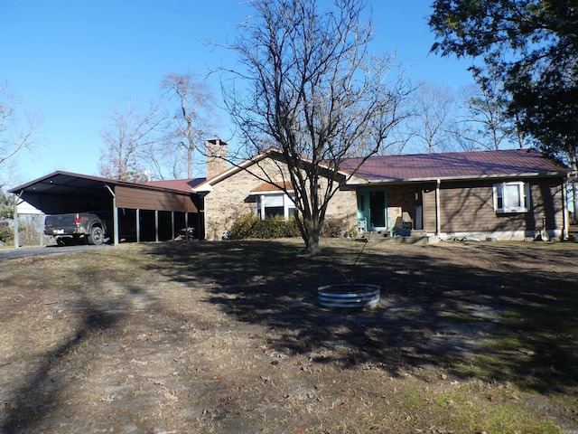 281 Polk Rd Unit 412, Mena, AR 71953 - view of front of property featuring a carport, metal roof, and a chimney