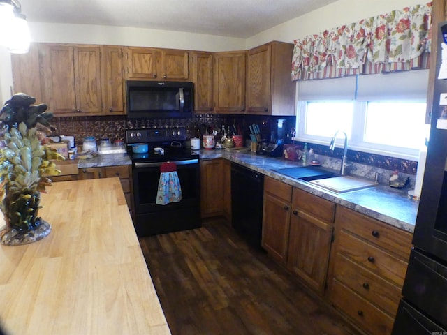 kitchen featuring sink, wooden counters, dark hardwood / wood-style floors, backsplash, and black appliances