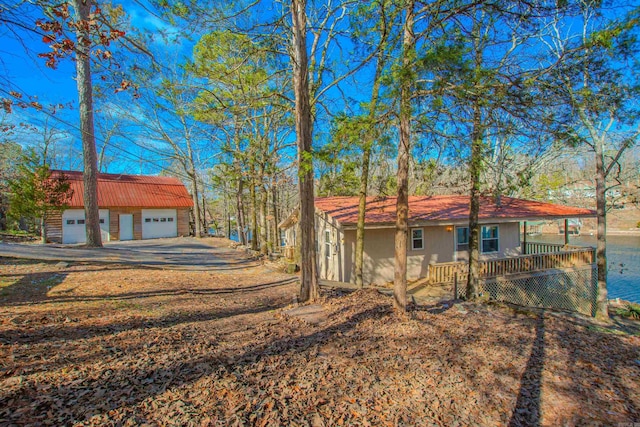 view of front of house featuring an outbuilding, covered porch, and a garage