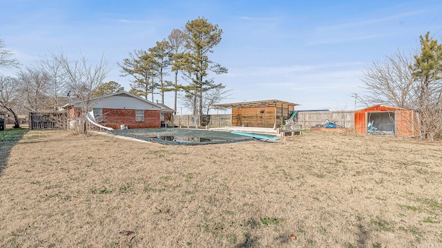 view of yard featuring an outbuilding and a covered pool