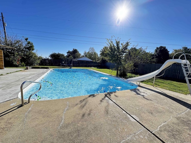 view of swimming pool featuring a patio area and a water slide