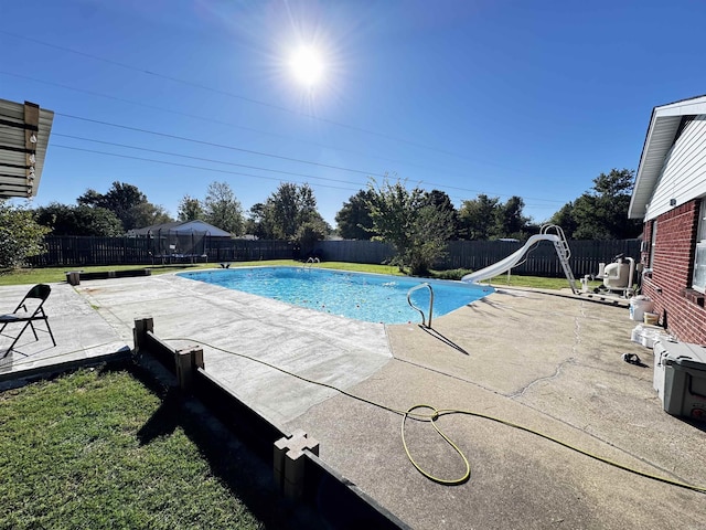 view of swimming pool featuring a patio and a water slide