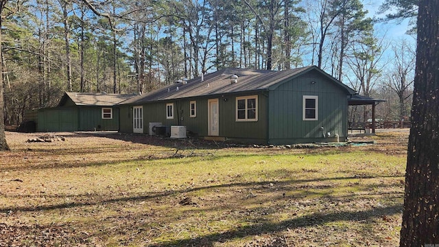 view of home's exterior with a lawn and central AC unit