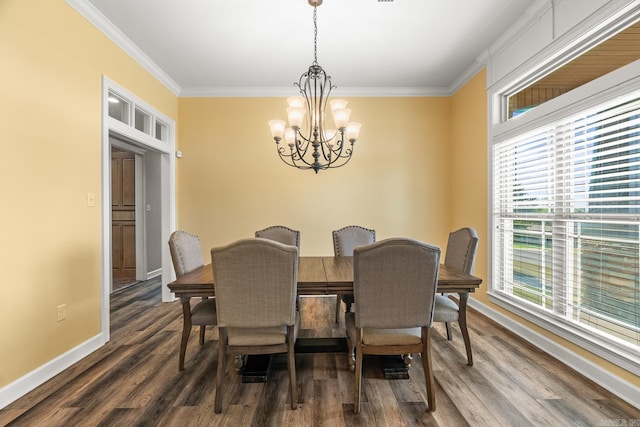 dining area with ornamental molding, dark hardwood / wood-style floors, and an inviting chandelier