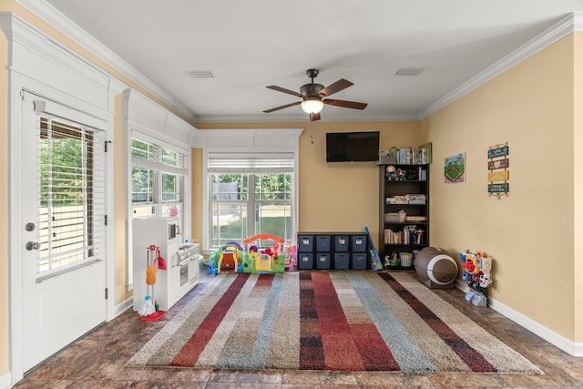 recreation room featuring ceiling fan and crown molding