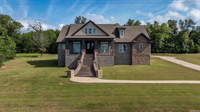 craftsman inspired home featuring a front lawn