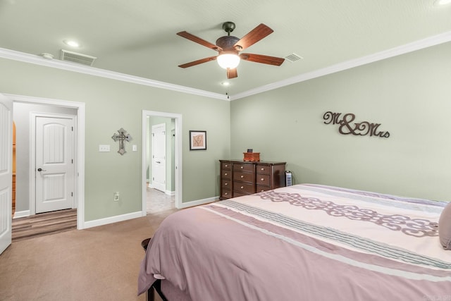 carpeted bedroom featuring ceiling fan and crown molding