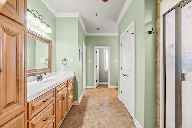 bathroom featuring tile patterned floors, crown molding, a shower with door, and vanity