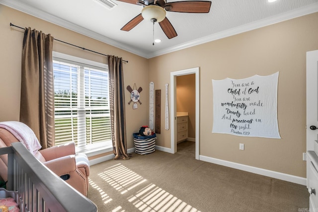 carpeted bedroom with ensuite bath, a nursery area, ornamental molding, and ceiling fan