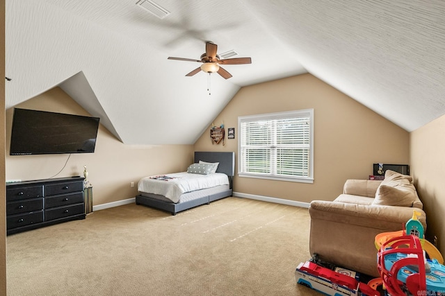 bedroom featuring a textured ceiling, ceiling fan, light colored carpet, and lofted ceiling