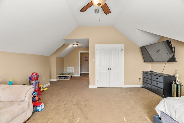 bedroom with ceiling fan, a closet, carpet, and lofted ceiling