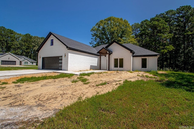 modern farmhouse with a garage and a front lawn