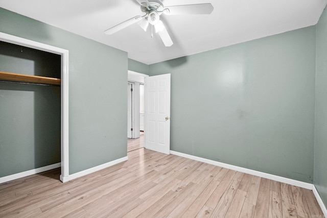 unfurnished bedroom with ceiling fan, a closet, and light wood-type flooring