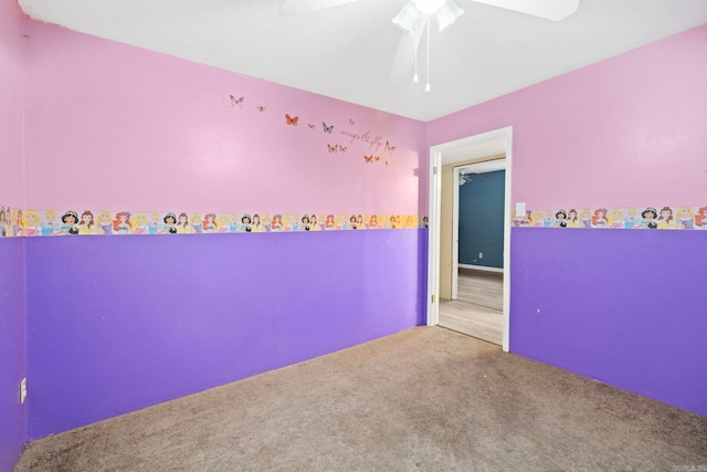 carpeted empty room featuring ceiling fan