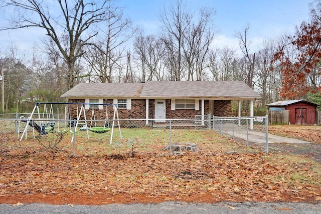 view of front facade with a playground and a shed