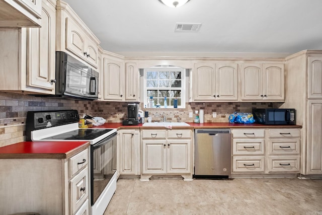 kitchen with electric range, dishwasher, cream cabinetry, and sink