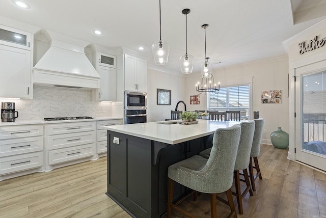 kitchen featuring light countertops, premium range hood, and glass insert cabinets