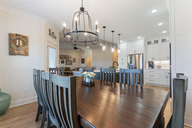 dining room featuring crown molding, recessed lighting, light wood-style flooring, a chandelier, and baseboards