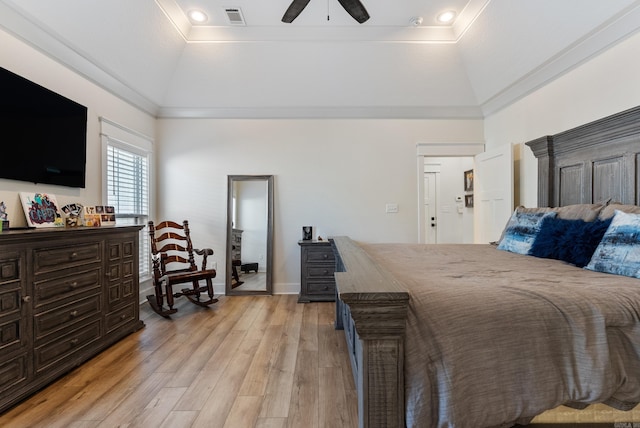 bedroom featuring light wood-type flooring, high vaulted ceiling, visible vents, and a tray ceiling