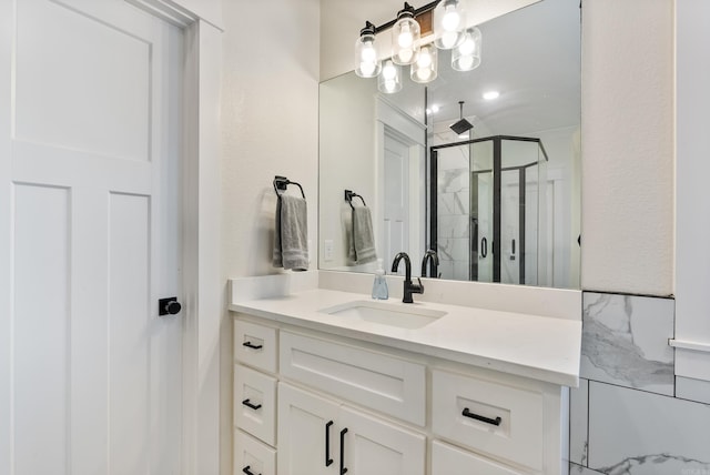 full bath with a stall shower and vanity