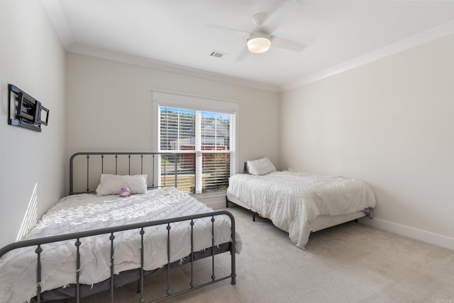 bedroom with light colored carpet, visible vents, ornamental molding, a ceiling fan, and baseboards